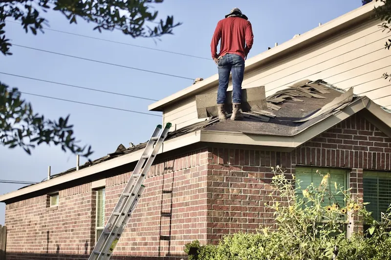 Professional roofer working on a residential roof in Highland Lake
